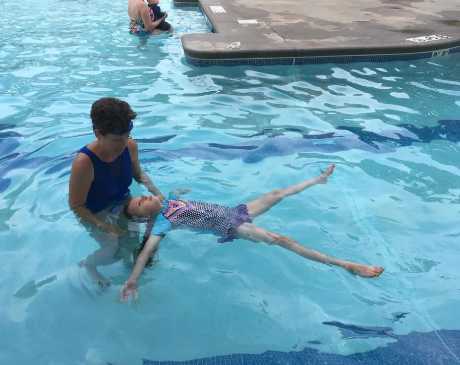a man and a child in a pool