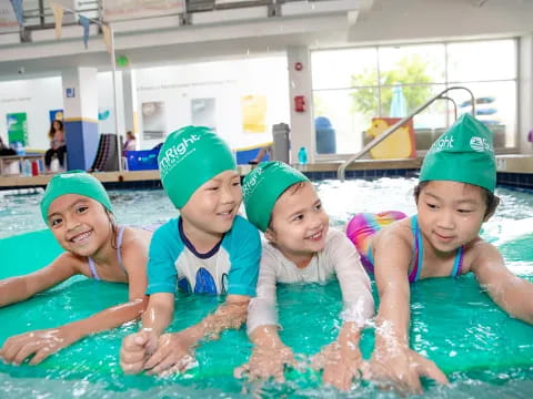 a group of children in a pool