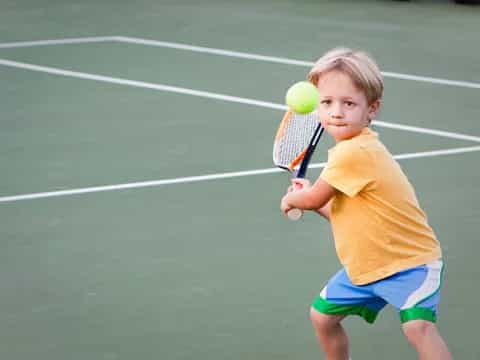 a boy playing tennis