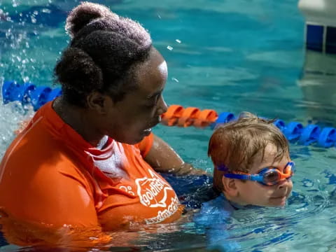 a man and a child in a pool