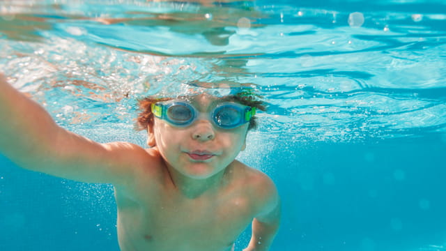 a child swimming in a pool