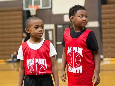 a couple of boys in basketball uniforms