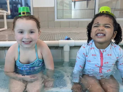 a couple of children in a pool