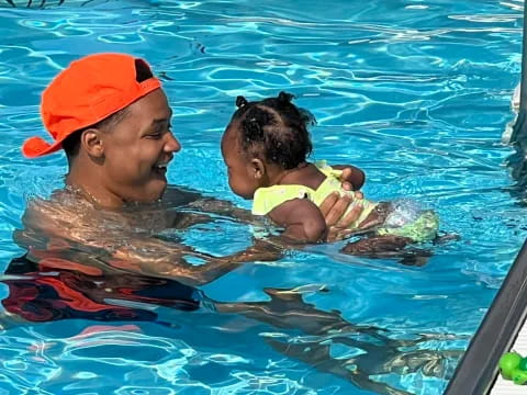 a person and a child in a pool