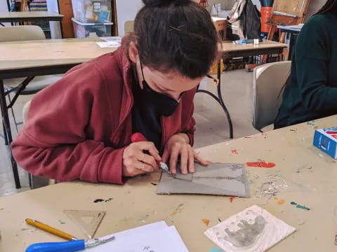 a person drawing on a table