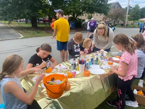 a group of people sitting around a table with food