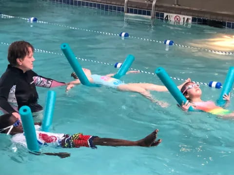 a man and a woman in a pool with a man in a pool