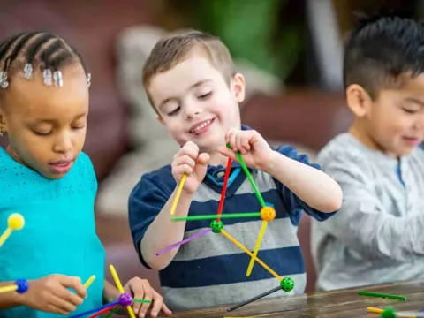 a group of children playing with colored pencils