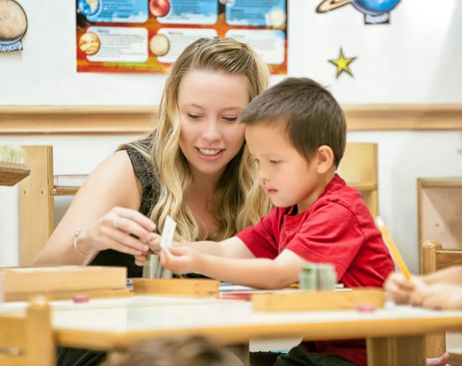 a person and a boy sitting at a table