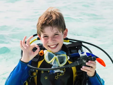a boy wearing goggles and smiling