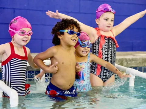 a group of children in a pool