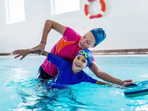 a couple of kids in a pool