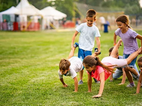 a group of people playing in the grass