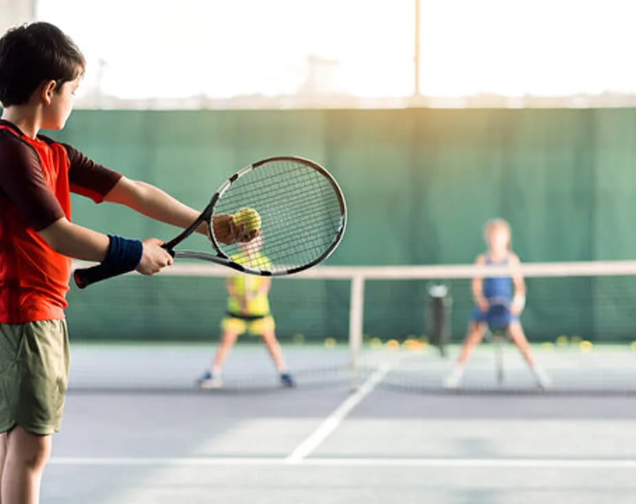 a kid playing tennis