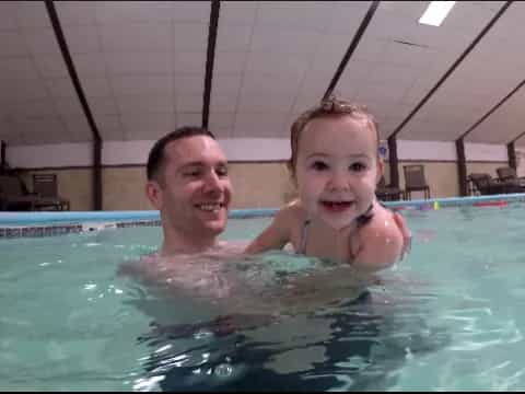 a woman and a child in a pool