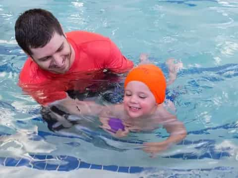 a man and a child in a pool