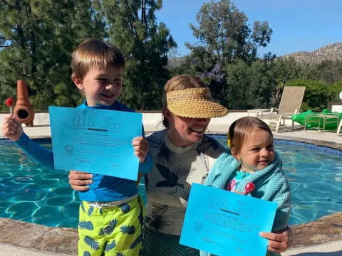 a person and two children holding signs