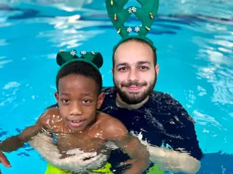 a person and a baby in a pool