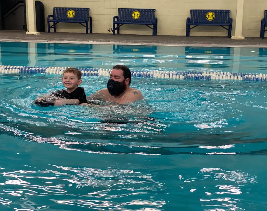 a person and a child in a pool