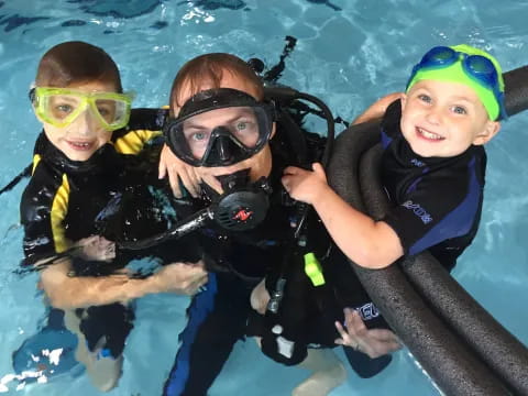 a group of kids in scuba gear