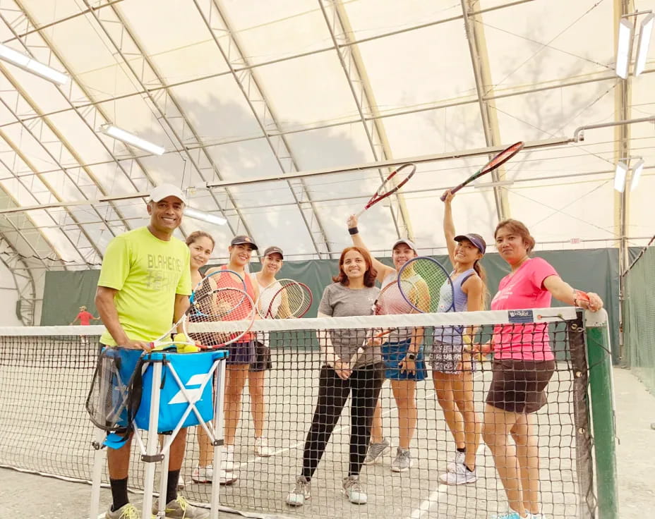 a group of people holding tennis rackets