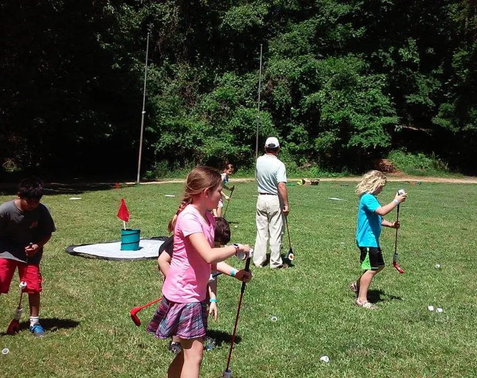 a group of people playing golf