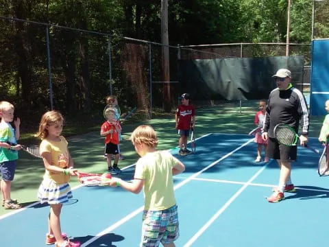 kids holding tennis rackets