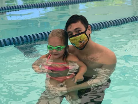 a person and a boy in a pool