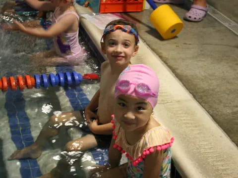 a couple of children in a pool