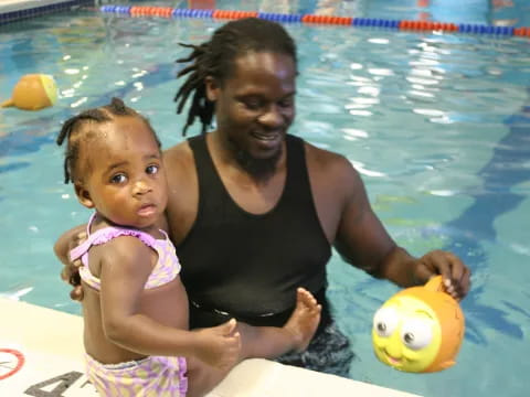 a person and a baby in a pool