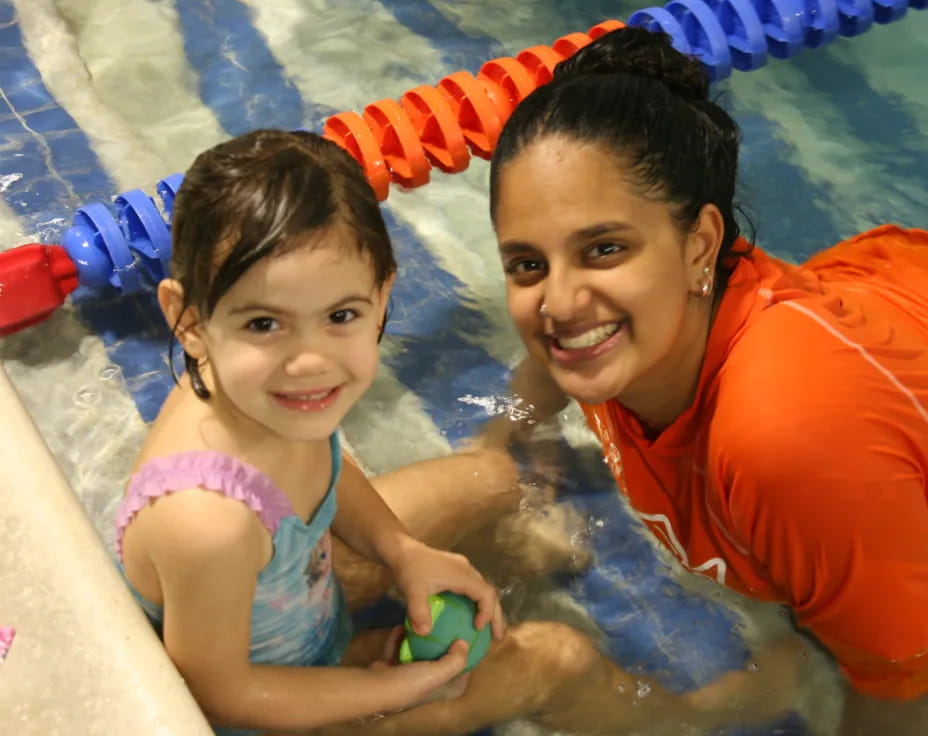 a person and a child in a pool