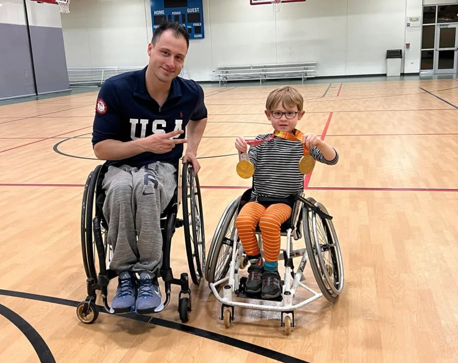 a man and a boy in wheelchairs