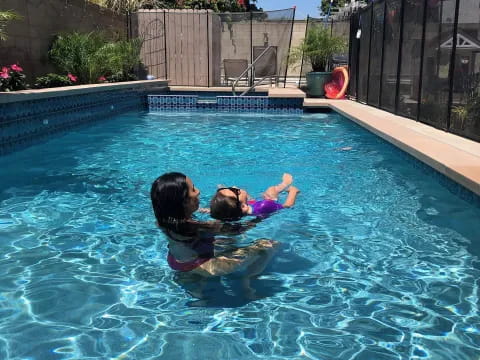 a person and a child in a pool