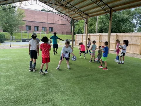 a group of kids playing football