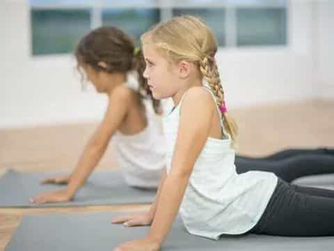 a couple of women doing yoga