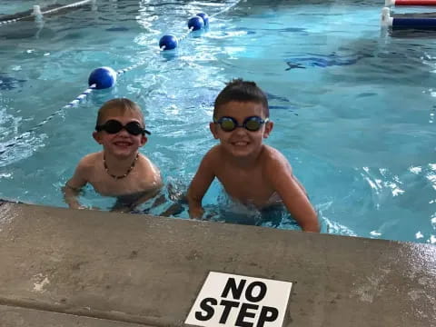 a couple of kids in a pool