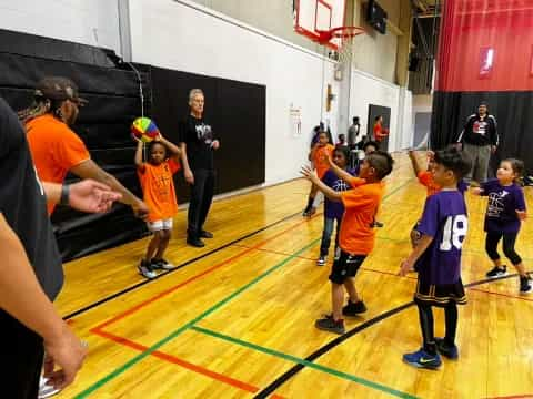 a group of kids playing basketball