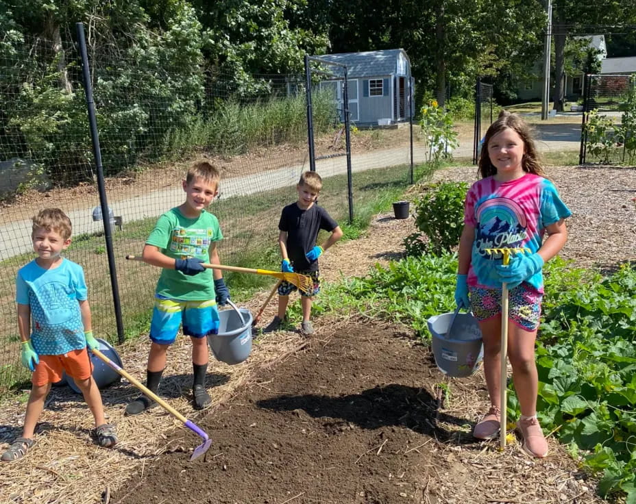 a group of children digging in the dirt