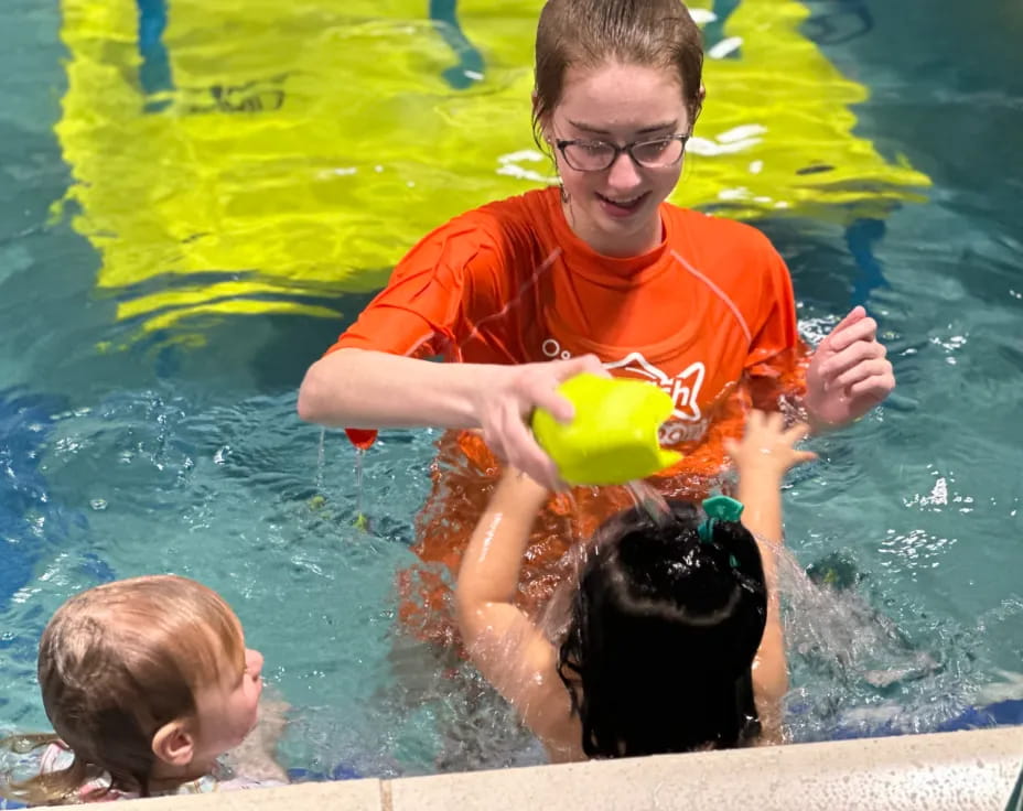 a person and two children in a pool