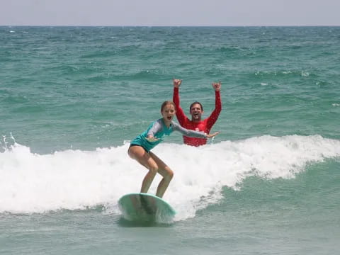 a man and a woman surfing
