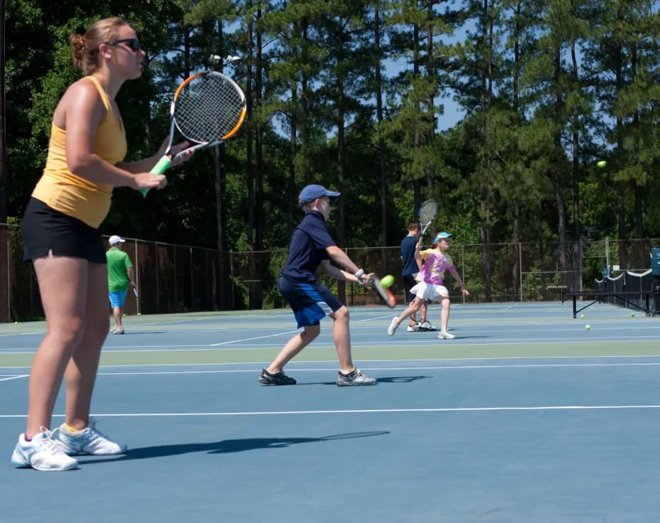 a woman hitting a ball with a tennis racket