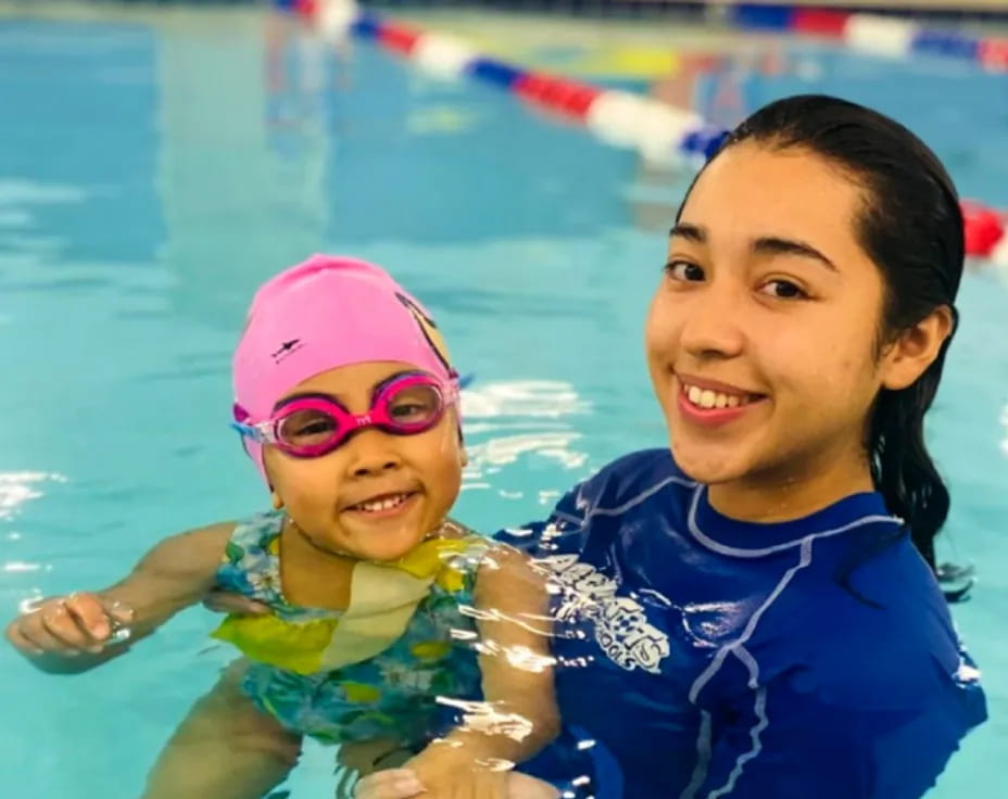 a person and a child in a pool