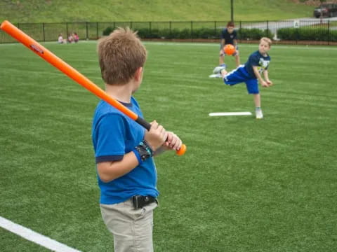 a kid holding a baseball bat