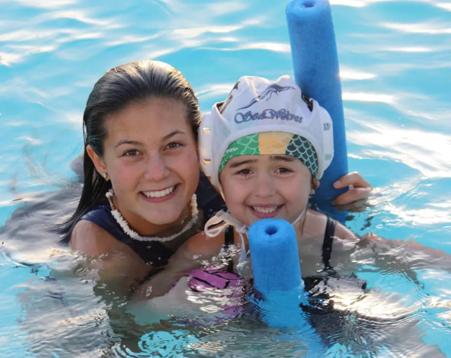 a person and a child in a pool