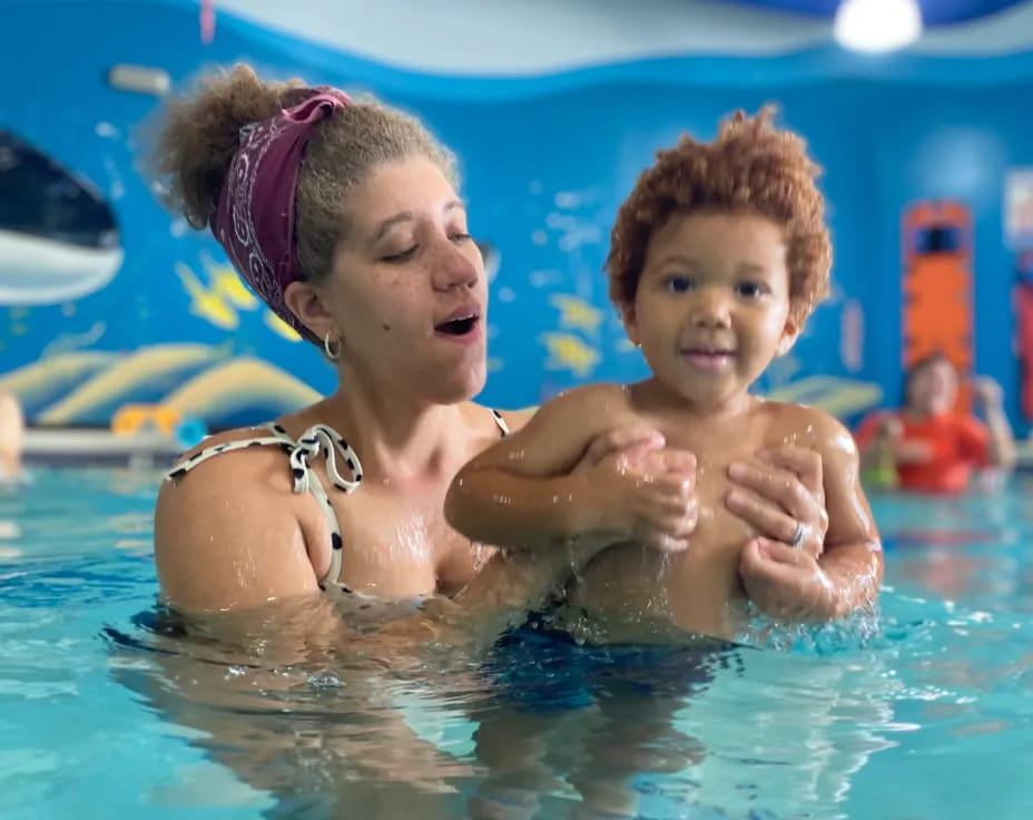 a person and a child in a pool