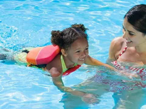 a person and a child in a pool