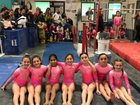 a group of girls in pink shirts