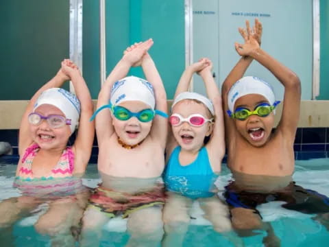 a group of children in a pool