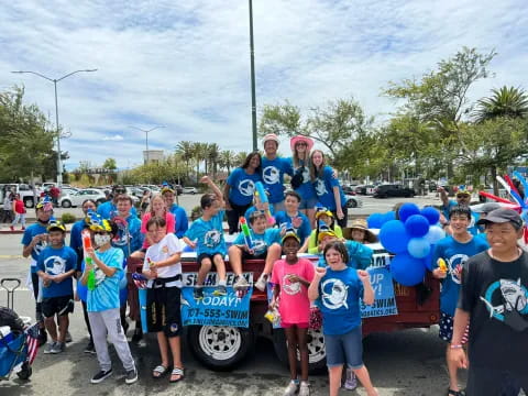 a group of people posing for a photo with balloons