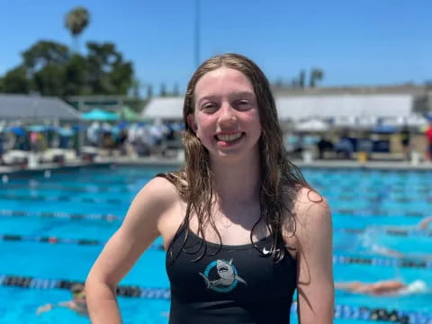 a woman in a swimsuit in front of a pool